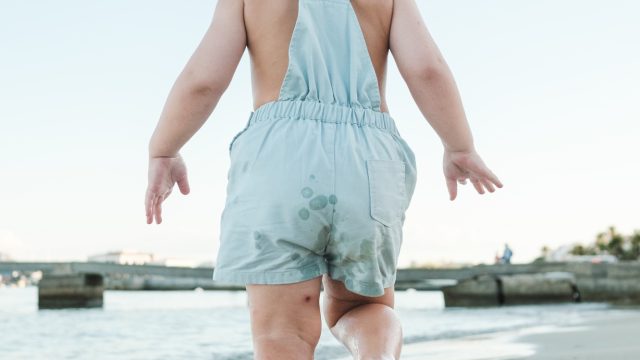 little-barefoot-toddler-in-summer-suit-walking-on-sandy-beach.jpg